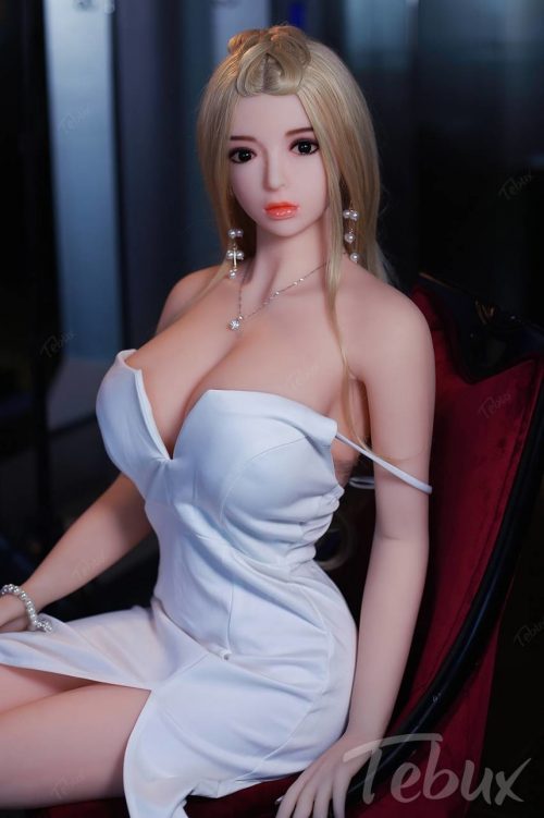 blonde Full Size Sex Dolls in short white dress sitting in a chair