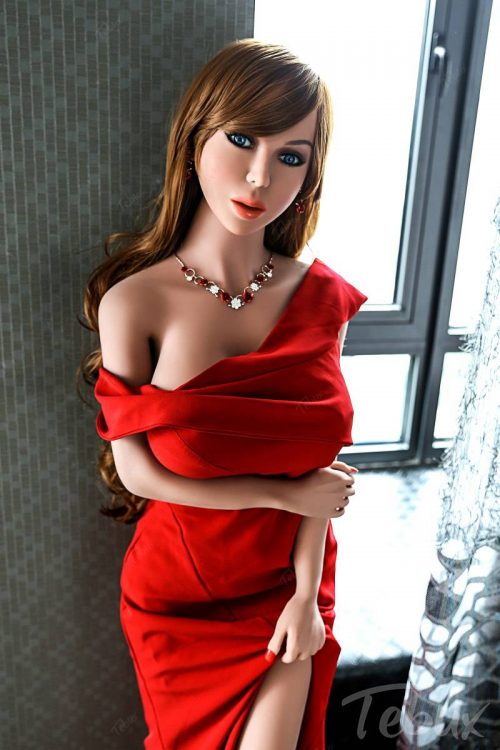 Big boobs sexdoll Meredith standing wearing red dress