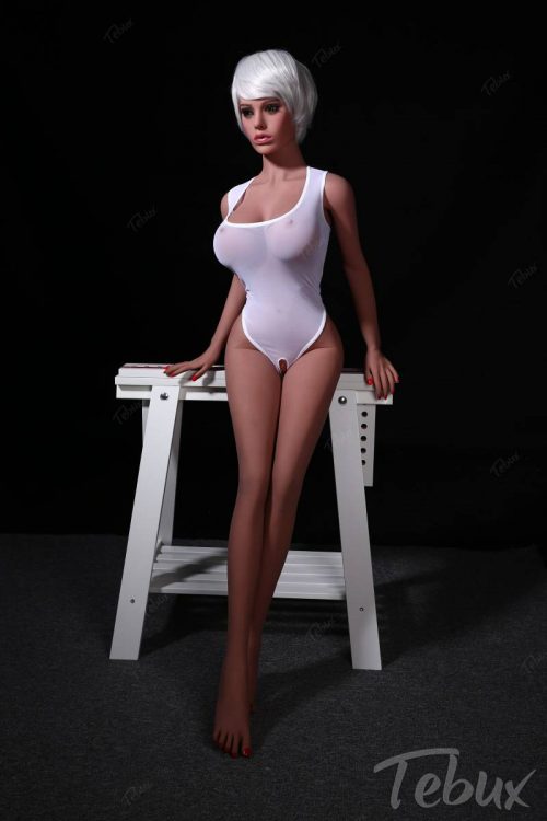 Inexpensive sex doll Amara standing wearing white top